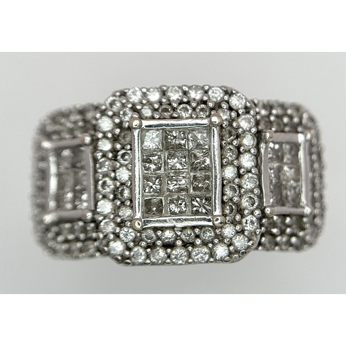 130 - An 18K White Gold Diamond Dress Ring. An array of pave round and princess cut diamonds c. 1.2ctw. Si... 