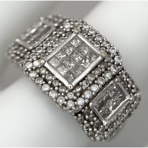 130 - An 18K White Gold Diamond Dress Ring. An array of pave round and princess cut diamonds c. 1.2ctw. Si... 