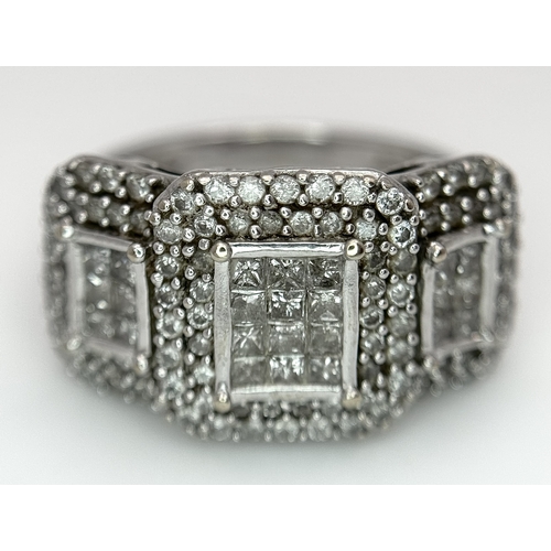 130 - An 18K White Gold Diamond Dress Ring. An array of pave round and princess cut diamonds c. 1.2ctw. Si... 