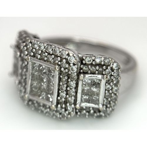 130 - An 18K White Gold Diamond Dress Ring. An array of pave round and princess cut diamonds c. 1.2ctw. Si... 