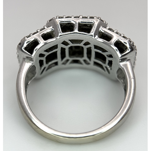 130 - An 18K White Gold Diamond Dress Ring. An array of pave round and princess cut diamonds c. 1.2ctw. Si... 