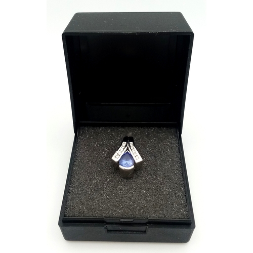 133 - Sophisticated 18 CARAT WHITE GOLD PENDANT. Having a PEAR CUT SAPPHIRE mounted to centre with DIAMOND... 