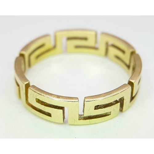136 - A 14K GOLD RING WITH GREEK KEY CUTOUT DESIGN.    3gms.    size O