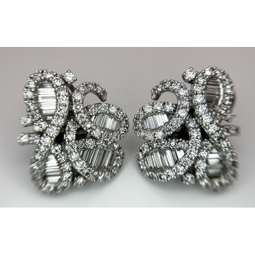 137 - A Fabulous Pair of 18K White Gold and Diamond Cocktail Earrings. Baguette and round brilliant cut in... 