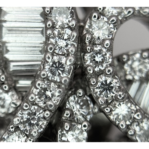 137 - A Fabulous Pair of 18K White Gold and Diamond Cocktail Earrings. Baguette and round brilliant cut in... 