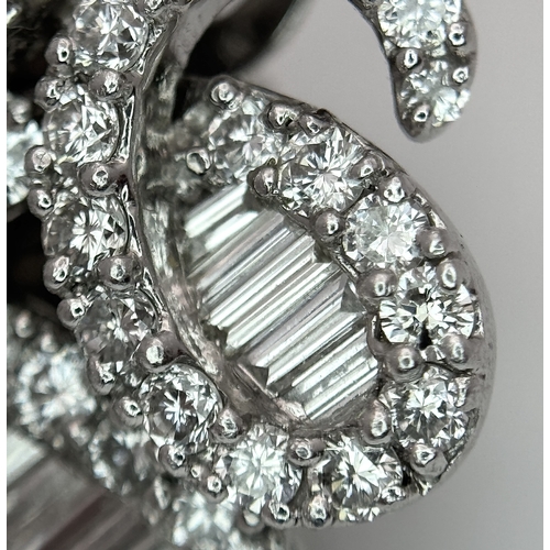 137 - A Fabulous Pair of 18K White Gold and Diamond Cocktail Earrings. Baguette and round brilliant cut in... 