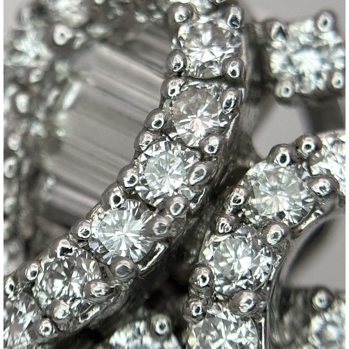 137 - A Fabulous Pair of 18K White Gold and Diamond Cocktail Earrings. Baguette and round brilliant cut in... 