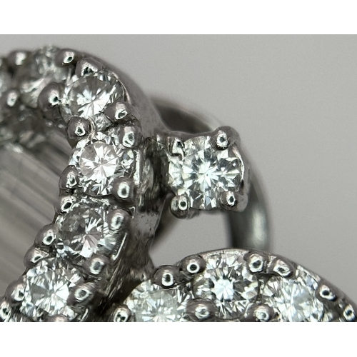 137 - A Fabulous Pair of 18K White Gold and Diamond Cocktail Earrings. Baguette and round brilliant cut in... 
