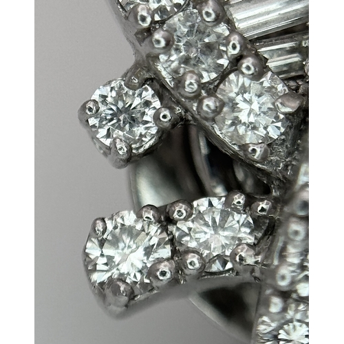 137 - A Fabulous Pair of 18K White Gold and Diamond Cocktail Earrings. Baguette and round brilliant cut in... 
