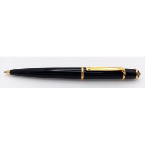 1052 - A Stylish Cartier Diabolo Black and Gold, Blue Sapphire Cabochon Ballpoint Pen, 13.7cm Length.