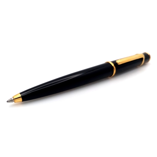 1052 - A Stylish Cartier Diabolo Black and Gold, Blue Sapphire Cabochon Ballpoint Pen, 13.7cm Length.