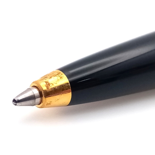 1052 - A Stylish Cartier Diabolo Black and Gold, Blue Sapphire Cabochon Ballpoint Pen, 13.7cm Length.