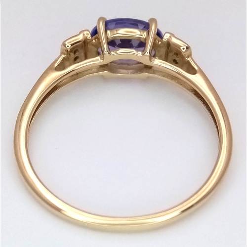 1059 - A Beautiful 10 Carat Yellow Gold Tanzanite and Diamond Set Ring Size N, set with a 7mm Oval Cut Tanz... 