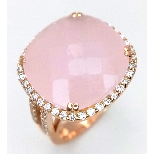 An 18K White Gold, Pink Moonstone and Diamond Cocktail Ring. Cushion cut faceted c.12ct moonstone with F colour and VS1 clarity diamond surround. Size M 1/2. 8.31g total weight. MT16