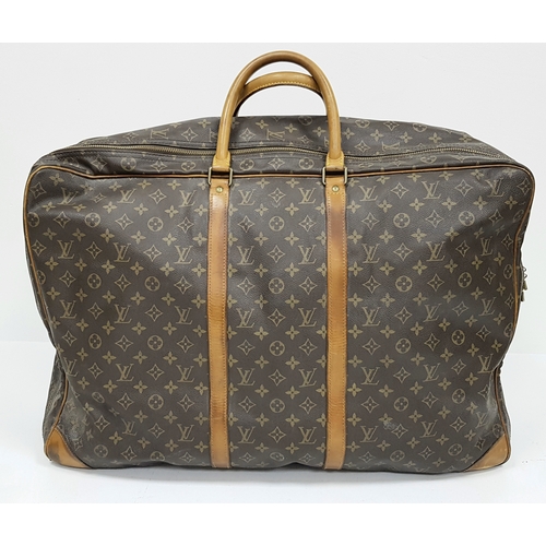 144 - A Louis Vuitton Brown Monogram Keepall Travel Bag. Brown monogram coated canvas exterior with gold-t... 