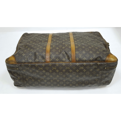 144 - A Louis Vuitton Brown Monogram Keepall Travel Bag. Brown monogram coated canvas exterior with gold-t... 