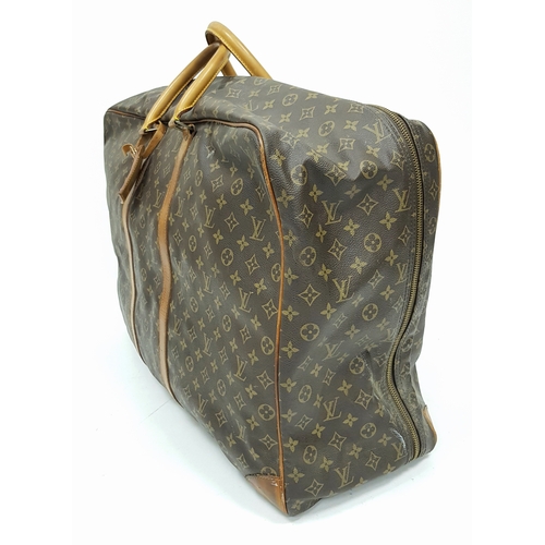 144 - A Louis Vuitton Brown Monogram Keepall Travel Bag. Brown monogram coated canvas exterior with gold-t... 