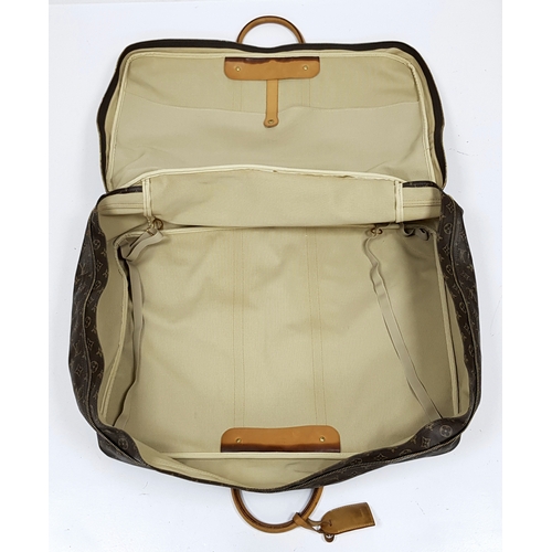 144 - A Louis Vuitton Brown Monogram Keepall Travel Bag. Brown monogram coated canvas exterior with gold-t... 