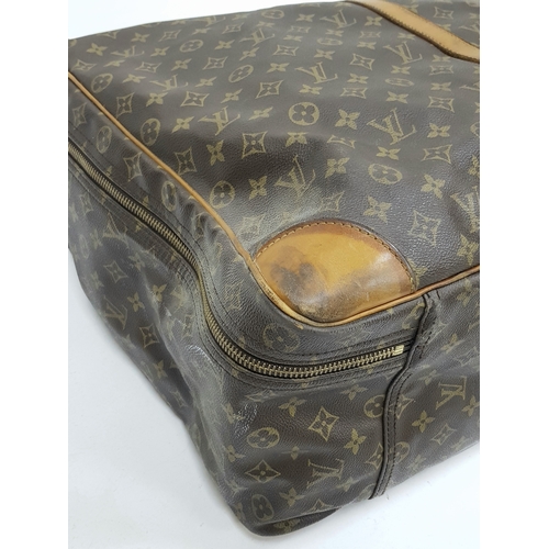 144 - A Louis Vuitton Brown Monogram Keepall Travel Bag. Brown monogram coated canvas exterior with gold-t... 
