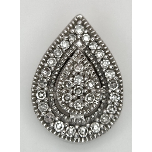 526 - A 9K White Gold, Diamond Pave Pair Shaped Pendant. 12mm. 
1.25g.