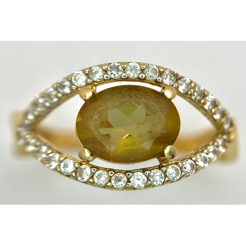 533 - A 14K Yellow Gold, Green stone (possibly tourmaline) and White Stone Ring in Eye Form. 1.75ct oval c... 