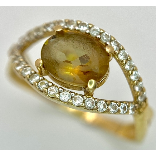 533 - A 14K Yellow Gold, Green stone (possibly tourmaline) and White Stone Ring in Eye Form. 1.75ct oval c... 
