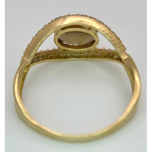 533 - A 14K Yellow Gold, Green stone (possibly tourmaline) and White Stone Ring in Eye Form. 1.75ct oval c... 