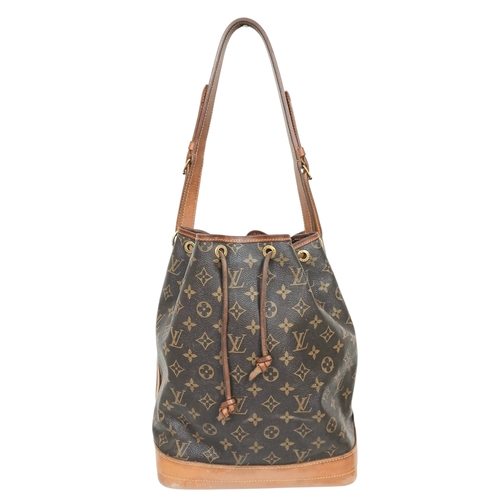 A Louis Vuitton Brown Monogram No&eacute; Shoulder Bag. Brown monogram coated canvas exterior with gold-toned hardware, adjustable leather shoulder strap and drawstring closure. Brown textile interior with a single main compartment. Some signs of scratches, wear and tear to the exterior and some stains and marks to the interior. Approx 34cm length x 28cm height x 19cm width. Comes with a dust cover. Please see photos or request a condition report. Ref: 26983.