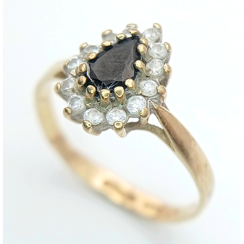 506 - A PRETTY 9K GOLD RING WITH TEARDROP SAPPHIRE CENTRE STONE WITH A HALO OF CZ STONES .     1.6gms    s... 