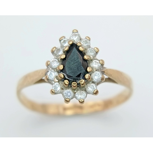 506 - A PRETTY 9K GOLD RING WITH TEARDROP SAPPHIRE CENTRE STONE WITH A HALO OF CZ STONES .     1.6gms    s... 