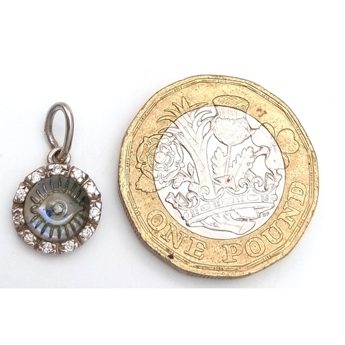 507 - AN 18K WHITE GOLD, DIAMOND SET, EVIL EYE PENDANT. 1.1G. SC 5033