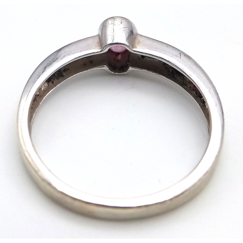 534 - A 9K White Gold, Pink Sapphire and Diamond Ring. Size L 1/2. 2.4g. MT26.