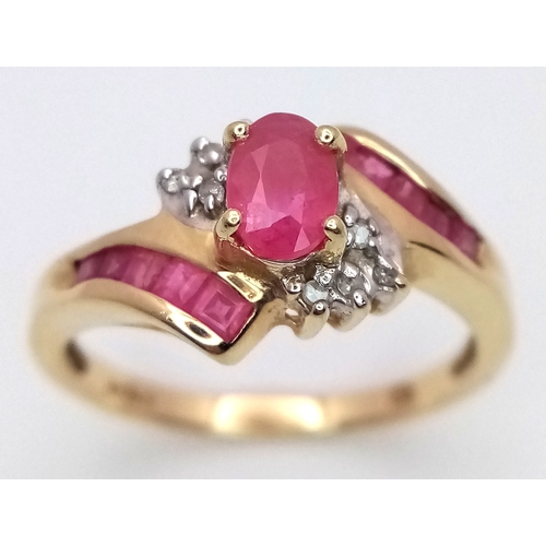 1039 - A 9K Yellow Gold Ruby and Diamond Crossover Ring. Oval and square cut rubies with small diamond acce... 