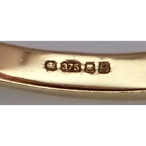 1039 - A 9K Yellow Gold Ruby and Diamond Crossover Ring. Oval and square cut rubies with small diamond acce... 