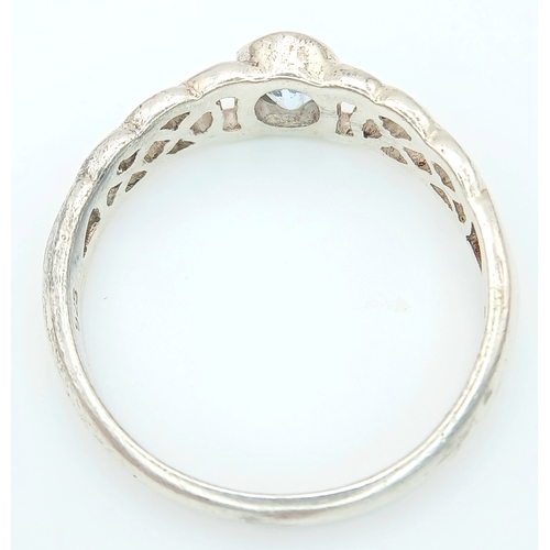 1077 - A Vintage Celtic Design Sterling Silver and Blue Topaz Ring Size S. Set with a 6 x 4mm Oval Cut Blue... 