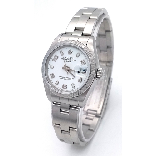 A Rolex Oyster Automatic Ladies Watch. Stainless steel bracelet and case - 26mm. Model 79190. Opaque white dial with date window. In working order. Comes with a Watch Register Report. PN-8335.