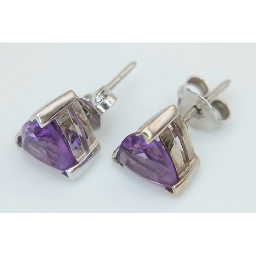 509 - A Pretty Pair of 9 Carat White Gold Trillion Cut, Top Colour, Amethyst Stud Earrings. The Earrings m... 
