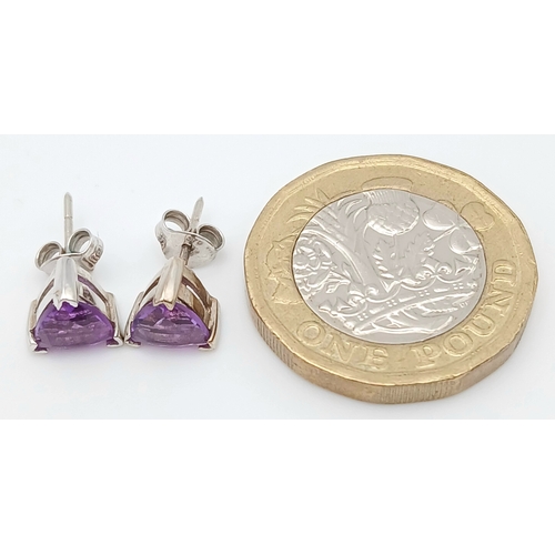 509 - A Pretty Pair of 9 Carat White Gold Trillion Cut, Top Colour, Amethyst Stud Earrings. The Earrings m... 