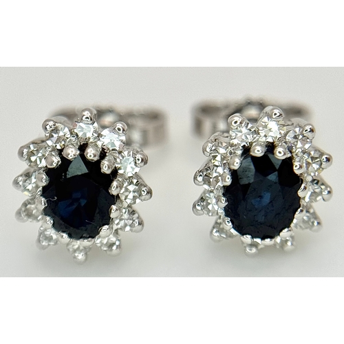 554 - A Pair of 9K White Gold, Sapphire and Diamond Stud Earrings. 2.35g total weight. MT34.