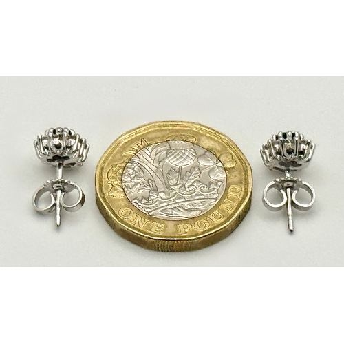 554 - A Pair of 9K White Gold, Sapphire and Diamond Stud Earrings. 2.35g total weight. MT34.
