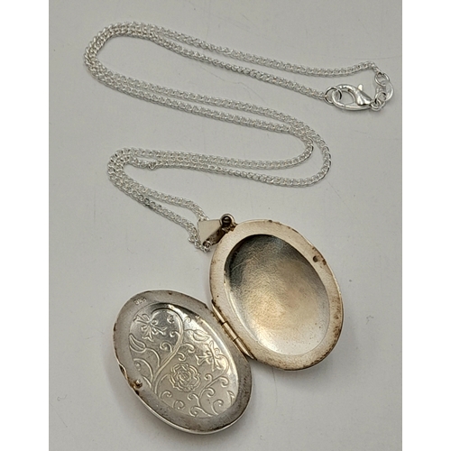 557 - A Vintage Sterling Silver Scroll and Love Poem Detailed Locket Pendant on a later 46cm Sterling Silv... 