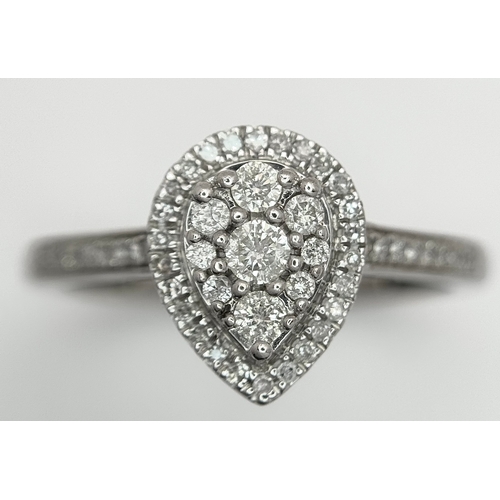 559 - A 9K WHITE GOLD, DIAMOND SET, PEAR SHAPED HALO CLUSTER RING. 0.28TCW, 2.5G, SIZE O. 10127