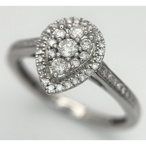 559 - A 9K WHITE GOLD, DIAMOND SET, PEAR SHAPED HALO CLUSTER RING. 0.28TCW, 2.5G, SIZE O. 10127