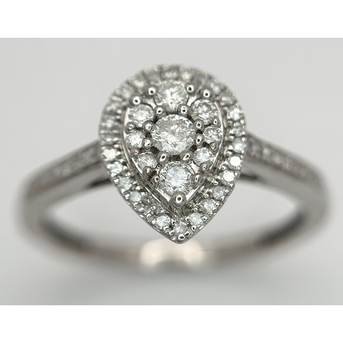 559 - A 9K WHITE GOLD, DIAMOND SET, PEAR SHAPED HALO CLUSTER RING. 0.28TCW, 2.5G, SIZE O. 10127