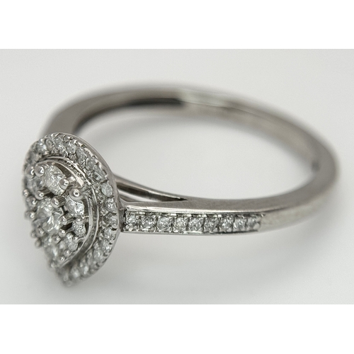 559 - A 9K WHITE GOLD, DIAMOND SET, PEAR SHAPED HALO CLUSTER RING. 0.28TCW, 2.5G, SIZE O. 10127