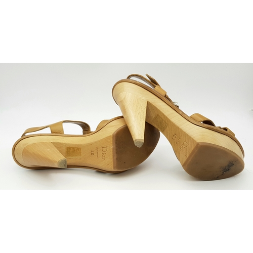 1047 - A Pair of Christian Dior Brown T-Strap Platform Heels. Leather with gold-toned hardware and wood hee... 