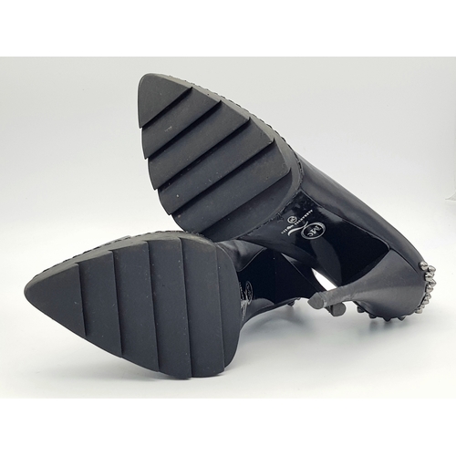 1054 - A Pair of Alexander McQueen Black Stud Heels. Leather exterior with stud embellishments. European si... 