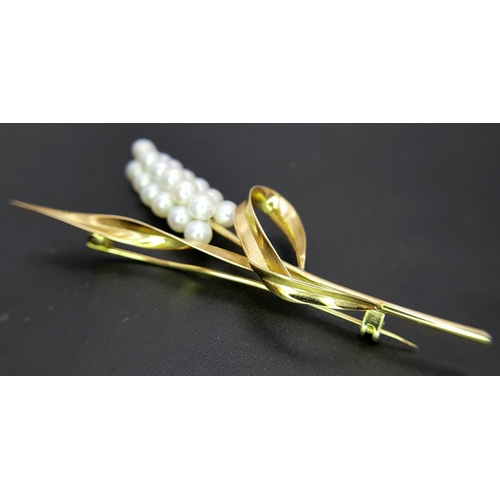 1096 - A 14K Yellow Gold and Pearl Brooch. Abstract form with almost a vine vibe that leads to 19 bright wh... 