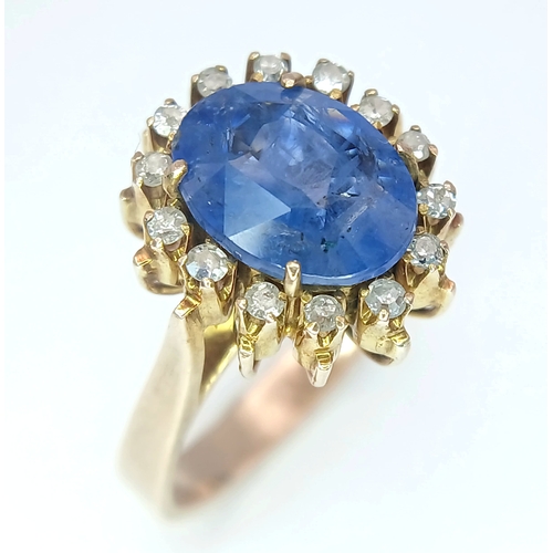 1110 - A 9K Yellow Gold Sapphire Ring. 4ct oval cut central sapphire with a white stone surround. Size K 1/... 