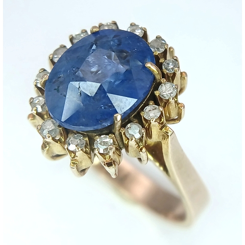1110 - A 9K Yellow Gold Sapphire Ring. 4ct oval cut central sapphire with a white stone surround. Size K 1/... 
